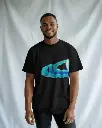 casual-studio-t-shirt-mockup-black-male-model-smiling-in-relaxed-white-backdrop-02122.webp